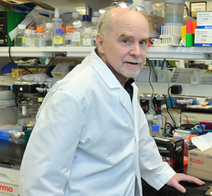 Photo of Dr. John O'Shea in the lab.