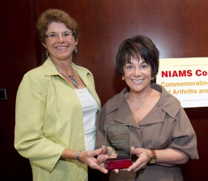 Arthritis patient Dr. Janet Stearns Wyatt (l) presents the NIAMS Coalition’s Congressional Champion Award to Rep. Anna Eshoo (D-CA).