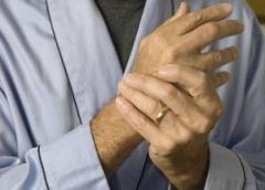 Older man holding wrist