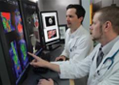 Dr. Peter Grayson (left), principal investigator of NIH’s Vasculitis Translational Research Program, reviews diagnostic images with Dr. Mark Ahlman at the NIH Clinical Center.