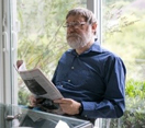An older man reading a book.
