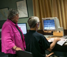 Two older adults using a computer.