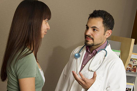 A male doctor talking with a woman patient