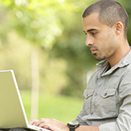 Hispanic male working on a laptop