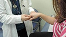 A doctor checking a girl hand