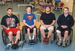 Four men in wheelchairs